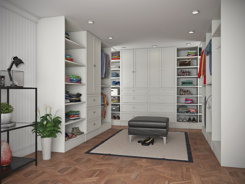 Huge walk-in closet with white doors & shelves. 